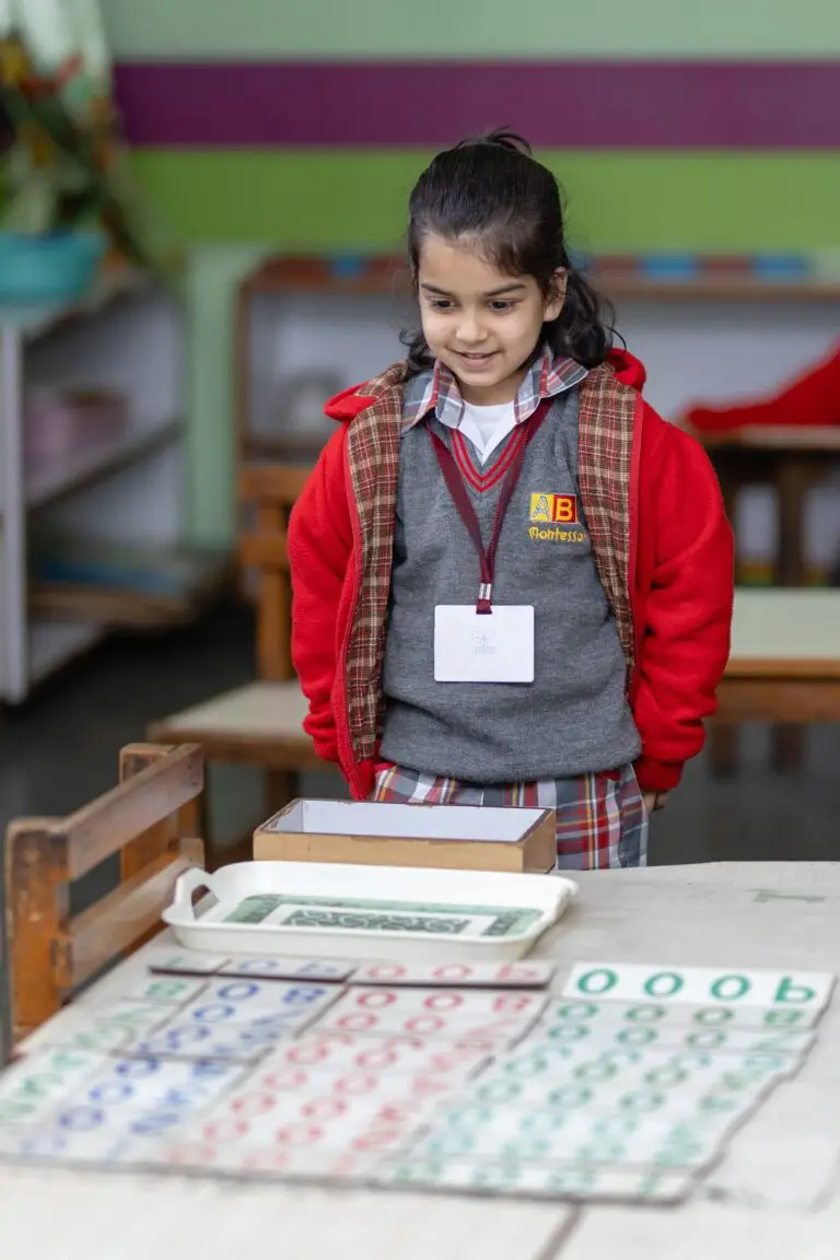 Home A child engaging with Montessori educational materials in a classroom setting.