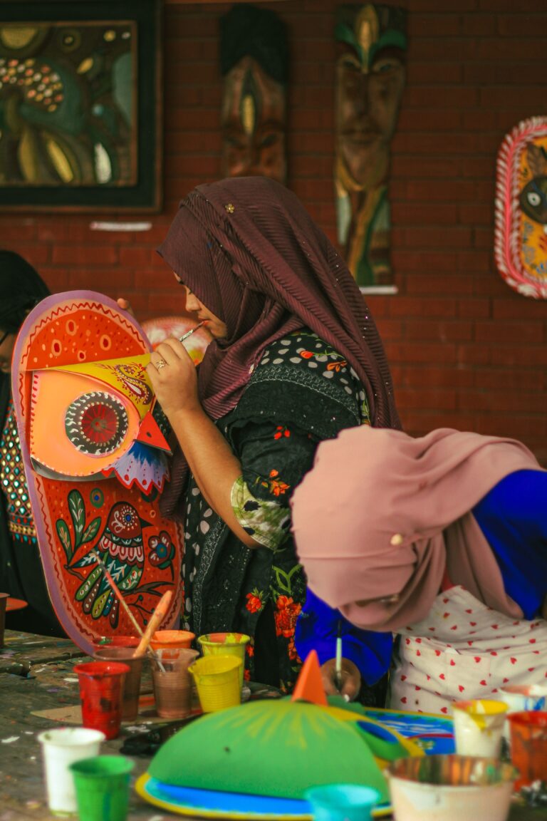 Home Women artistically painting traditional masks at a fine arts institution in Dhaka, Bangladesh.